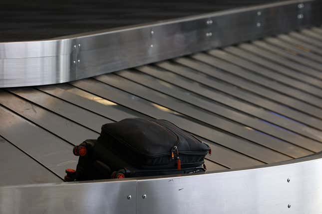 A suitcase at a baggage claim carousel