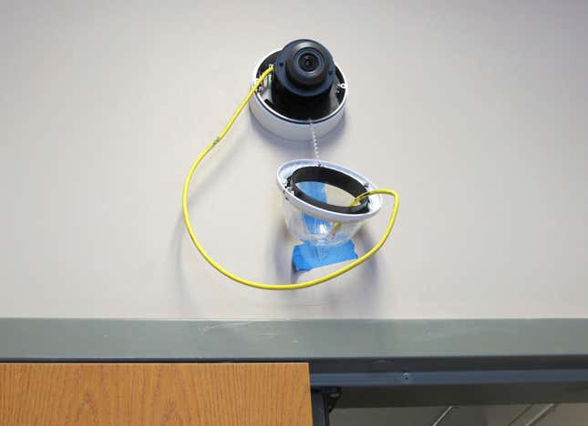 FILE - In this July 10, 2018, file photo, a camera with facial recognition capabilities hangs from a wall while being installed at Lockport High School in Lockport, N.Y. New York banned the use of facial recognition technology in schools Wednesday, Sept. 27, 2023, following a report that concluded the risks to student privacy and civil rights outweighed potential security benefits. (AP Photo/Carolyn Thompson, File)