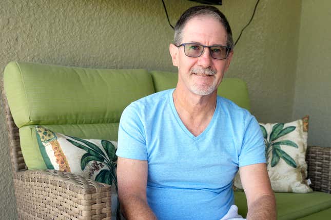 Scott Berkheiser, 57, who has Alzheimer&#39;s disease, sits for a portrait at his home Friday, April 5, 2024, in Venice, Fla. Insurance denials delayed Berkheiser’s first Leqembi infusion a few months until last December. He said the drugmaker eventually agreed to give it to him for free while he makes co-payments for the infusions. “It was a little crazy,” he said. “It seemed like it was kind of a game that must make sense for some monetary reason.” (AP Photo/Chris O&#39;Meara)