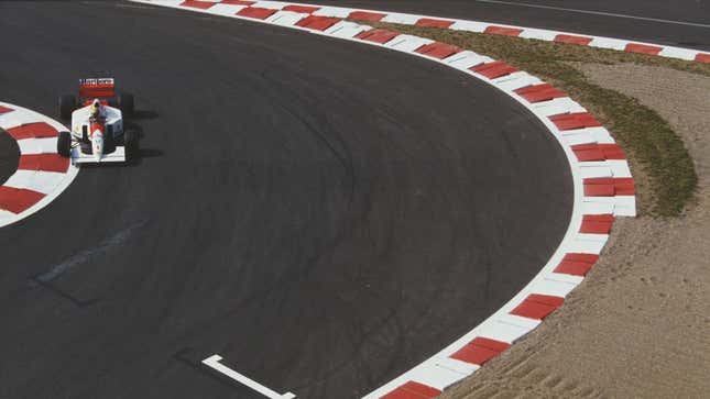 A vintage photo of McLaren F1 car racing in France. 