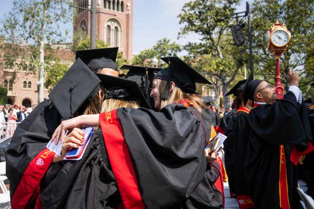 File - Graduates embrace during Southern California&#39;s 140th commencement ceremony, on May 12, 2023, in Los Angeles. Interest on federal student loans has started accumulating again after a three-year pause because of the COVID-19 pandemic. Borrowers still have another month before they&#39;ll need to start paying back loans. (Sarah Reingewirtz/The Orange County Register via AP, File)