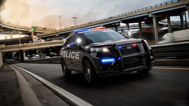 A Ford Explorer Police Interceptor driving with its lights on 