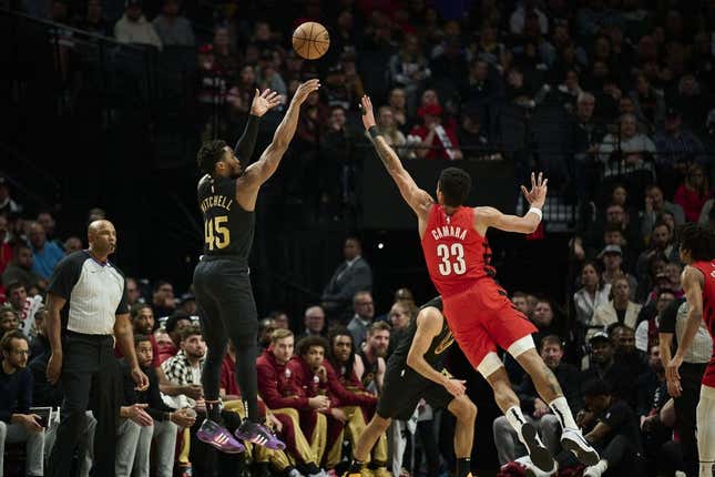 Nov 15, 2023; Portland, Oregon, USA; Cleveland Cavaliers guard Donovan Mitchell (45) shoots a basket during the first half against Portland Trail Blazers forward Toumani Camara (33) at Moda Center.