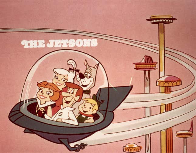 circa 1962: Die Cartoon-Familie „Die Jetsons“, bestehend aus George, Jane, Judy, Elroy und Astro, fliegt in einem Raumauto durch eine Weltraumstadt, in einem Standbild aus der Zeichentrickserie „Die Jetsons“ von Hanna-Barbera.