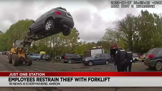 Screenshot of bodycam footage showing an SUV held in the air by a forklift