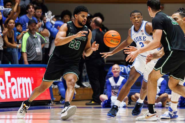 FILE - Dartmouth&#39;s Robert McRae III (23) takes a pass from Jackson Munro (33) as Duke&#39;s Jaylen Blakes (2) defends during the second half of an NCAA college basketball game in Durham, N.C., Nov. 6, 2023. A National Labor Relations Board regional official has decided that Dartmouth basketball players are employees of the school, clearing the way for an election that would create the first-ever labor union for NCAA athletes. (AP Photo/Ben McKeown, File)