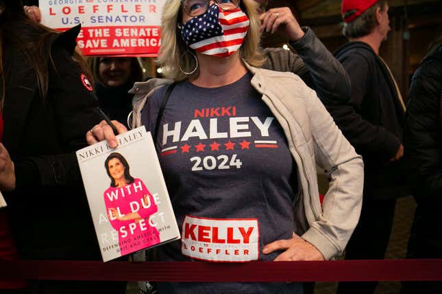 Tana Wagner waits to have her book signed by former U.N. Ambassador Nikki Haley during a campaign rally in support of Georgia Republican Senate candidates David Perdue (R-GA) and Kelly Loeffler (R-GA) on December 20, 2020 in Cumming, Georgia. The Senate Firewall campaign event comes ahead of a crucial runoff election for Perdue and Loeffler on January 5th that will determine what party controls the United States Senate