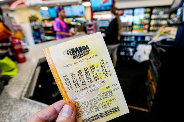 FILE - A Mega Millions ticket is seen as a person makes a purchase inside a convenience store, Aug. 7, 2023, in Kennesaw, Ga. The winning numbers for a nearly $1 billion Mega Millions lottery prize will be drawn Friday night, March 22, 2024, offering the hope of sudden riches for a lucky player and almost certain disappoint for everyone else. (AP Photo/Mike Stewart, File)