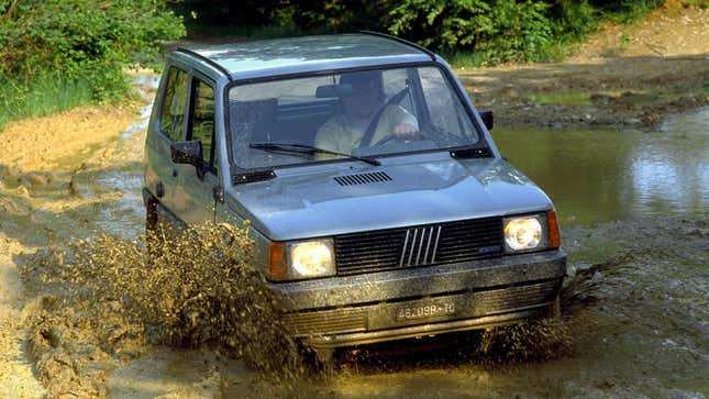 A Fiat panda drives through a muddy river