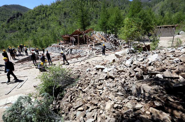 Journalists and North Korean officials look around the site where the 2nd tunnel and an observatory of Punggye-ri nuclear test ground were blown up during the dismantlement process in Punggye-ri, North Hamgyong Province, North Korea May 24, 2018.