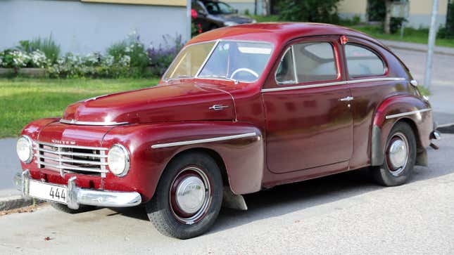 A red 1954 Volvo PV444 HS