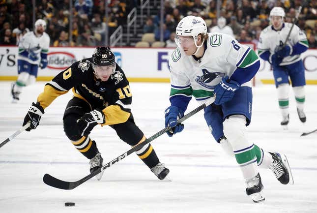 Jan 11, 2024; Pittsburgh, Pennsylvania, USA; Vancouver Canucks right wing Brock Boeser (6) skates up ice with the puck against Pittsburgh Penguins left wing Drew Oâ€™Connor (10) during the second period at PPG Paints Arena.