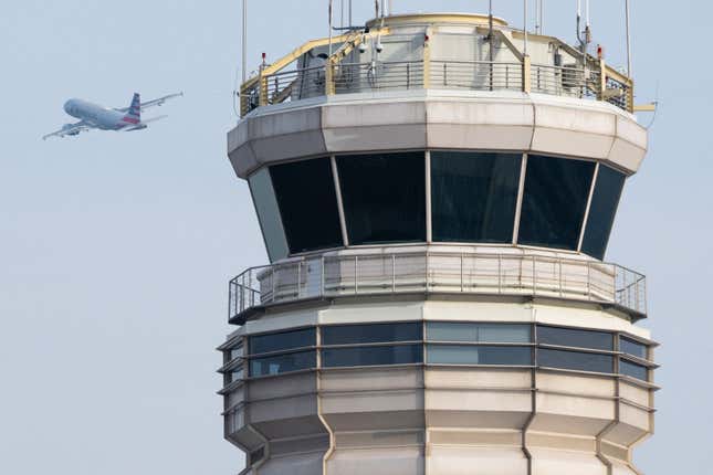 An American Airlines Airbus A319 airplane takes off past the air traffic control tower at Ronald Reagan Washington National Airport
