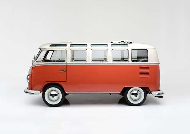 An orange and white '65 VW bus with squat oval windows between the side windows and the sunroof.