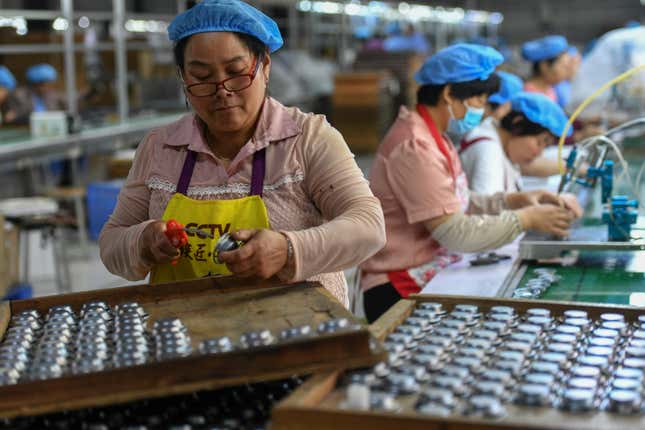 FILE - Workers assemble speakers at an electronics factory in Linquan in central China&#39;s Anhui province on May 31, 2023. China&#39;s factories picked up their pace and retail sales also gained momentum in August, the government reported Friday, Sept. 15, suggesting the economy may be gradually recovering from its post-pandemic malaise. (Chinatopix Via AP, File)