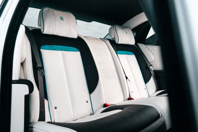 The rear seat of a Rolls-Royce Ghost with bee accents