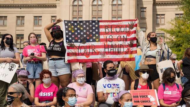 ATLANTA, GA - OCTOBER 02: Demonstrators hold signs as they rally in support of women's reproductive rights at the Georgia State Capitol on October 2, 2021 in Atlanta, Georgia. The Women's March and other groups organized marches across the country to protest the new abortion law in Texas. (Photo by Megan Varner/Getty Images)