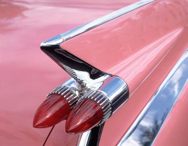 The fin of a pink Cadillac and two taillights