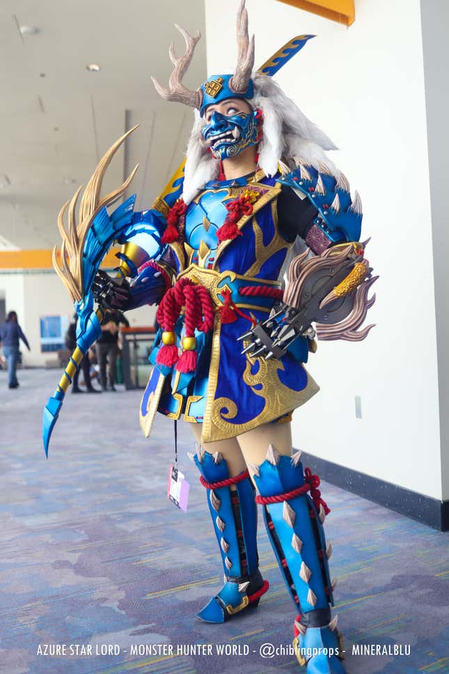 A blue, red, and gold-armored Azure Star Lord poses in the hallway at a convention. 