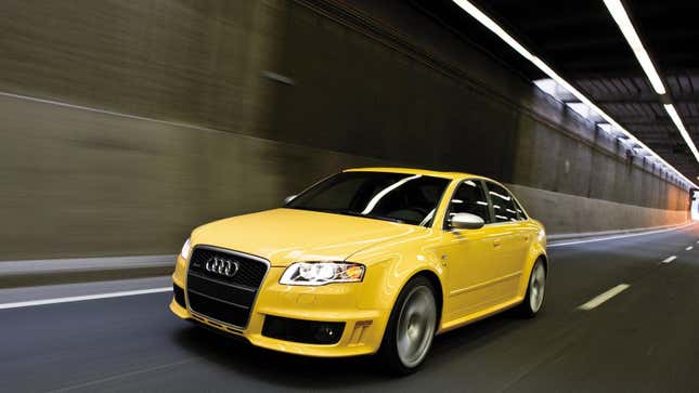 A bright yellow Audi RS4 driving through a tunnel from the front 3/4 angle