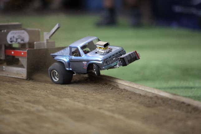 An RC truck popping a wheelie while competing in the sled pull