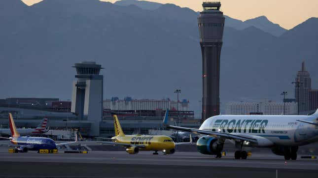 A Frontier Airlines plane prepare to take off from Harry Reid International Airport as Southwest Airlines and Spirit Airlines planes taxi