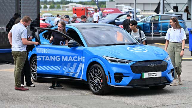 Visitors view the all-electric Ford Mustang Mache during the British Motor Show at Farnborough International Exhibition Centre on August 17, 2023 in Farnborough, England.