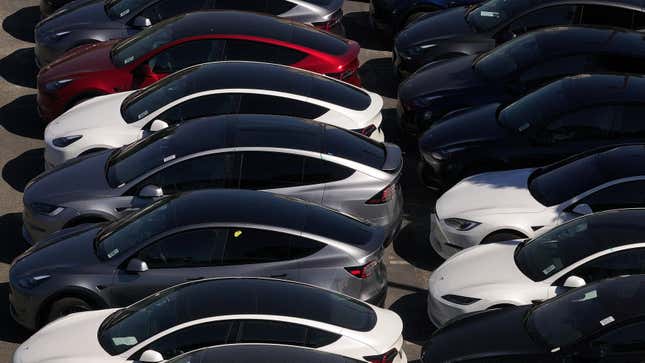 : In an aerial view, brand new Tesla cars sit parked at a Tesla dealership on May 31, 2024 in Corte Madera, California.