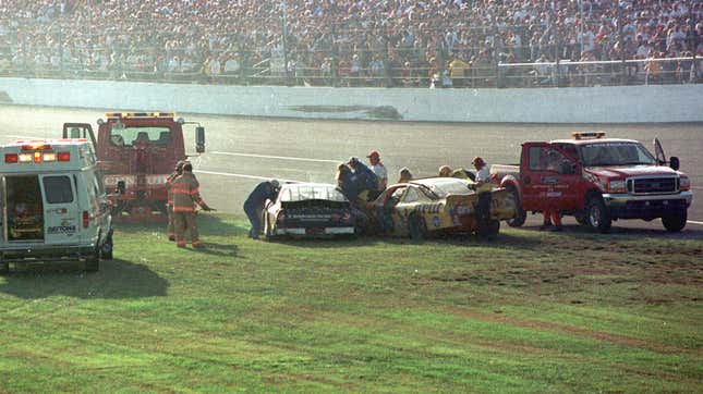Rescue workers arrive at Dale Earnhardt's Goodwrench Chevrolet after a crash during the running of the 43rd Daytona 500 at the Daytona International Speedway February 18, 2001 in Daytona Beach, FL. NASCAR officials confirmed the 49-year-old, 78-time Winston Cup Champion driver, died in a crash on the final lap of the race.
