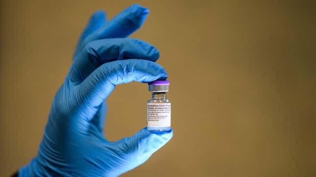 A health care worker in the Uk holding a vial of the Pfizer/BioNTech Covid-19 vaccine. 