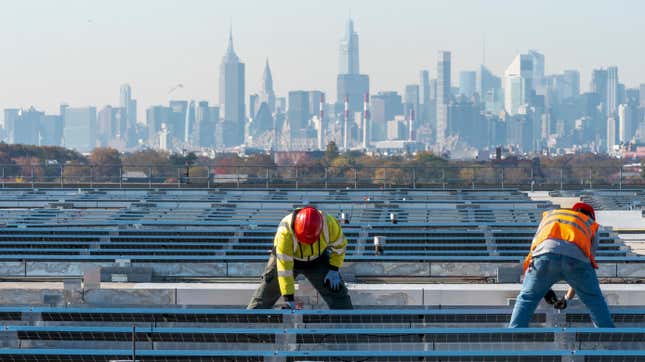 IBEW Local 3 workers install a solar panel on top of LaGuardia Airport in New York City. 