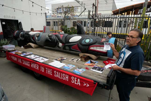 FILE - Freddie Lane, a member of the Lummi Nation who traveled from Washington State, with a totem pole touring across the country to stop the degradation of Native lands, joins members of the Apache Stronghold group gathered in the Los Angeles neighborhood of Boyle Heights at Self Help Graphics &amp; Art paint protest signs on Monday, March 20, 2023. An Apache group that has fought to protect land it considers sacred from a copper mining project in central Arizona suffered a significant blow Friday, March 1, 2024, when a divided federal court panel voted 6-5 to uphold a lower court&#39;s denial of a preliminary injunction to halt transfer of land for the project. (AP Photo/Damian Dovarganes, File)