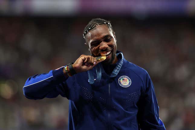 PARIS, FRANCE - AUGUST 05: Gold medalist Noah Lyles of Team United States celebrates on the podium during the Men’s 100m medal ceremony on day ten of the Olympic Games Paris 2024 at Stade de France on August 05, 2024 in Paris, France. 