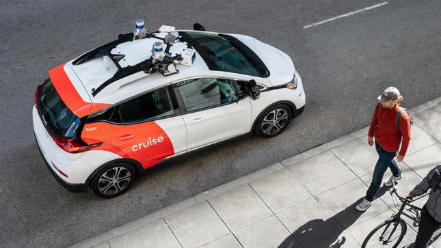 A GM Cruise robotaxi parks on the side of a road in a press image