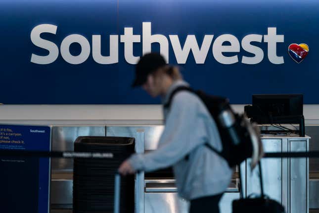 FILE - A traveler walks through the Southwest ticketing counter area at the Los Angeles International Airport in Los Angeles, April 18, 2023. Federal officials said Thursday, April 4, 2024, that they are investigating a Southwest Airlines flight that veered off course and flew close to the air traffic control tower at LaGuardia Airport last month. (AP Photo/Jae C. Hong, File)