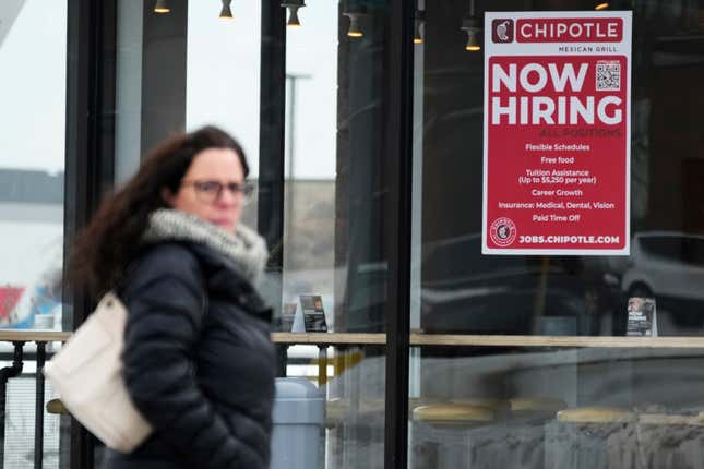 FILE - A hiring sign is displayed at a Chipotle restaurant in Schaumburg, Ill., Jan. 30, 2023. Job gains and raises helped power solid economic growth in the U.S. last year, but what if those gains were a mirage? The Labor Department overestimated job gains last year by about 13%. That suggests some of Wall Street’s optimism last year was built on sand. A weaker employment market means a weaker case for consumer spending to keep propping up the economy. (AP Photo/Nam Y. Huh, file)