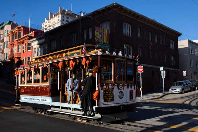 A cable car runs down a San Francisco street.