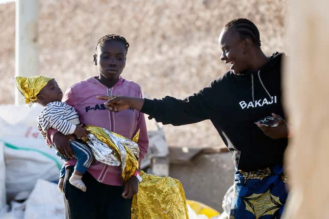 A migrant woman jokes with a baby after they reached the port of the Sicilian island of Lampedusa, southern Italy, Saturday, Sept. 16, 2023. Italian Premier Giorgia Meloni is vowing to take “extraordinary measures” to deal with an influx of migrants. Thousand of migrants reached the Italian island of Lampedusa on more than 100 boats this week (Cecilia Fabiano/LaPresse via AP)