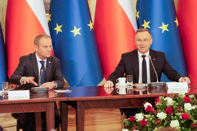 Poland&#39;s Prime Minister Donald Tusk, left, and President Andrzej Duda attend a meeting of the Cabinet Council, a consultation format between the president and the government, in Warsaw, Poland, on Tuesday Feb. 13, 2024. Tusk says he has documentation proving that state authorities under the previous government used powerful Pegasus spyware illegally and that list of victims was “very long.” (AP Photo/Czarek Sokolowski)