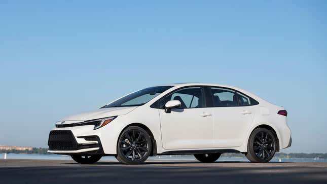 A photo of a white Toyota Corolla sedan. 