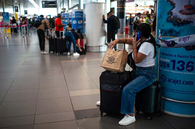 People walk with their luggage at Bogota’s El Dorado International Airport in Colombia, July 28, 2023.