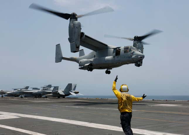 FILE -In this image provided by the U.S. Navy, Aviation Boatswain&#39;s Mate 2nd Class Nicholas Hawkins, signals an MV-22 Osprey to land on the flight deck of the USS Abraham Lincoln in the Arabian Sea on May 17, 2019. When the U.S. military took the extraordinary step of grounding its fleet of V-22 Ospreys this week, it wasn&#39;t reacting just to the recent deadly crash of the aircraft off the coast of Japan. The aircraft has had a long list of problems in its short history. (Mass Communication Specialist 3rd Class Amber Smalley/U.S. Navy via AP)