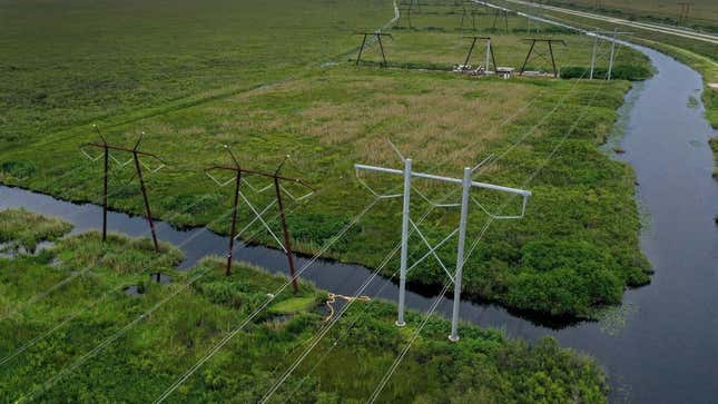  In an aerial view, electric power lines are seen attached to the transmission tower along the power grid on September 28, 2023 in the Everglades, Florida. 