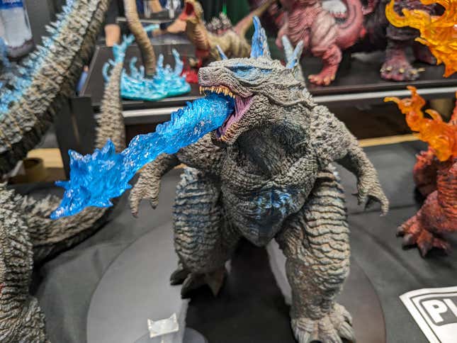 A statue of Godzilla with a breath attack sits on display.