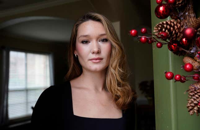 Nicole Plauché, 23, poses for a photo at her family&#39;s home in Highland Village, Texas, Friday, Dec. 15, 2023. Plauché graduated from college last year with a business degree and is navigating how to manage holiday spending while paying student loan debt. (AP Photo/LM Otero)