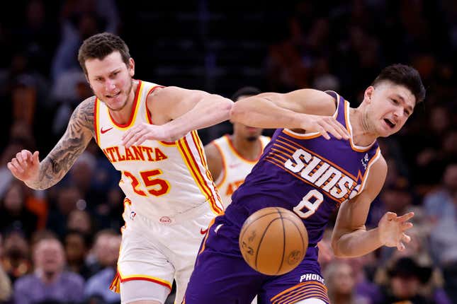 PHOENIX, ARIZONA - MARCH 21: Garrison Mathews #25 of the Atlanta Hawks and Grayson Allen #8 of the Phoenix Suns battle for a loose ball during the second half at Footprint Center on March 21, 2024 in Phoenix, Arizona. NOTE TO USER: User expressly acknowledges and agrees that, by downloading and or using this photograph, User is consenting to the terms and conditions of the Getty Images License Agreement.  (Photo by Chris Coduto/Getty Images)