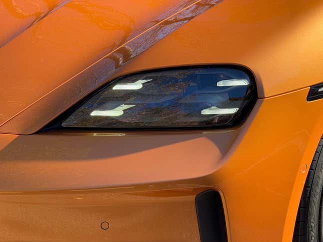 Headlight of a Nordic Gold 2025 Porsche Taycan GTS sedan