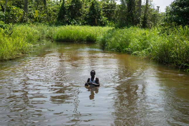 A boy swims in a river near areas affected by oil drilling, in the village of Kinkazi, outside Moanda, Democratic Republic of the Congo, Sunday, Dec. 24, 2023. (AP Photo/Mosa&#39;ab Elshamy)