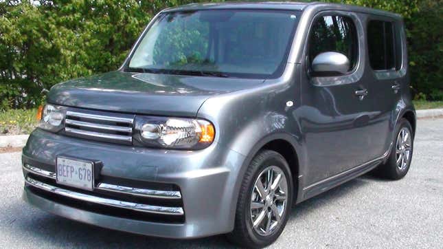 A front 3/4 shot of a 2010 Nissan Cube Krom in dark grey looking weird as ever