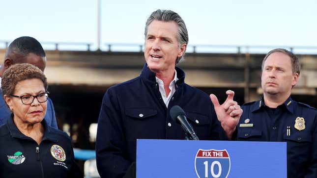 California Governor Gavin Newsom speaks at a press conference near the closed I-10 elevated freeway following a large pallet fire, which occurred Saturday at a storage yard beneath the freeway, on November 13, 2023 in Los Angeles, California.